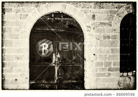 Vintage doors forged and rusty in a stone wall Vintage doors forged and rusty in a stone wall 88009598