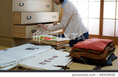 Middle-aged woman organizing kimono dance 88009688