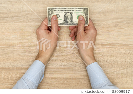 One dollar banknote in male hands One dollar banknote in male hands 88009917