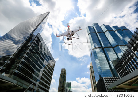 Drone with high resolution digital camera flying over city  88010533