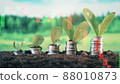 Coins with plants and live stock charts on a multilayered screen 88010873