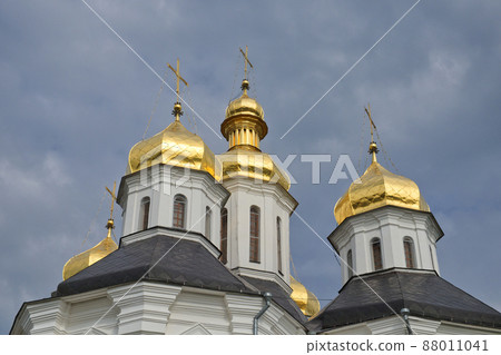 Gilded domes of an ancient Orthodox church against the sky. Gilded domes of an ancient Orthodox church against the sky. 88011041