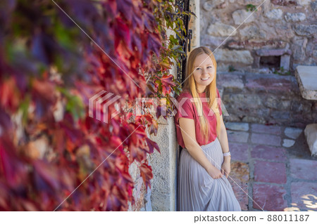 Woman tourist on background of beautiful view of the island of St. Stephen, Sveti Stefan on the Budva Riviera, Budva, Montenegro. Travel to Montenegro concept 88011187