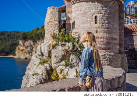 Young woman tourist in the old town of Budva. Travel to Montenegro concept Young woman tourist in the old town of Budva. Travel to Montenegro concept 88011213