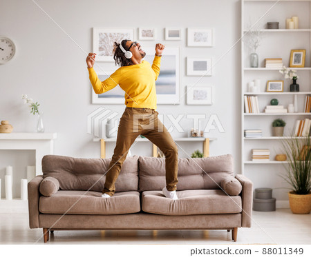 African American man meloman dancing on couch 88011349
