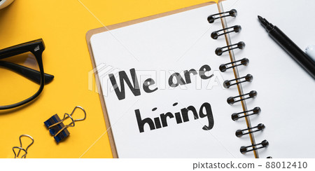 Writing on a notepad with a marker we are hiring. Writing on a notepad with a marker we are hiring. 88012410