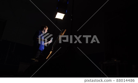 Artist copyist paint seascape with ship in ocean. Craftsman decorator draw as boat sail on blue sea. Black background. Wide angle shot. 88014486