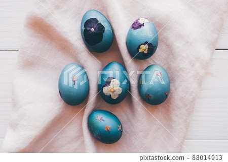 Pressed flower Easter eggs on beige tablecloth. Pressed flower Easter eggs on beige tablecloth. 88014913