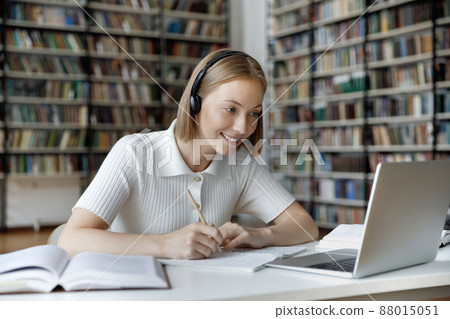 Happy young beautiful female student watching educational lecture. Happy young beautiful female student watching educational lecture. 88015051