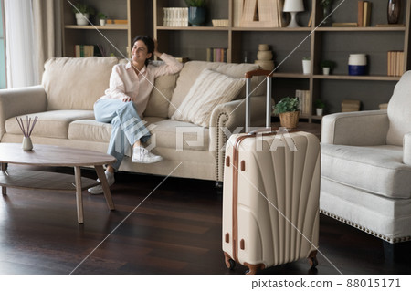 Happy Hispanic woman relaxing at home returning from vacation. 88015171