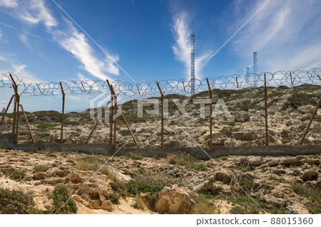 Military base with barbed wire fence. Military base with barbed wire fence. 88015360