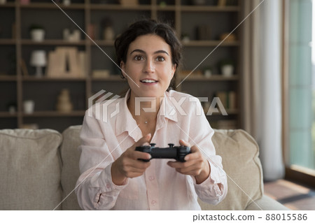 Addicted to modern technology happy young woman playing video game. 88015586