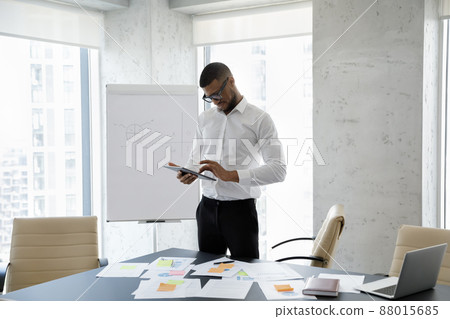 Happy successful young African American businessman using digital tablet. 88015685