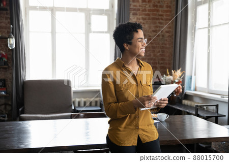Happy young African entrepreneur woman holding tablet computer 88015700