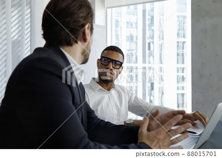 Young two diverse business partners discussing online project. 88015701