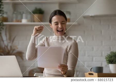 Happy woman celebrate great unbelievable news in paper letter 88015723