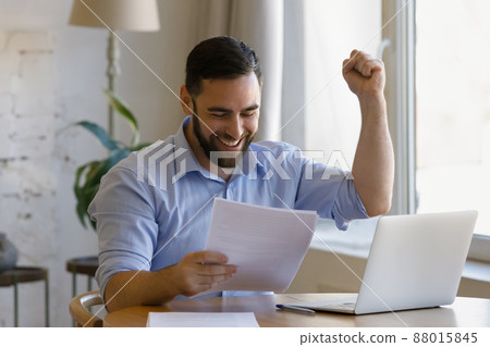 Man holding papers read information looks overjoyed, celebrate success 88015845