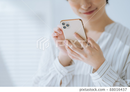 Hands of a woman operating a smartphone Hands of a woman operating a smartphone 88016437