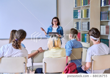 Lesson in classroom with digital screen for group of teenagers Lesson in classroom with digital screen for group of teenagers 88016755