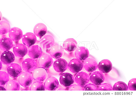plastic pink spherical ball capsules with selective focus isolated on white background plastic pink spherical ball capsules with selective focus isolated on white background 88016967