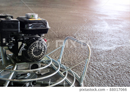 Power float grinder machine on wet concrete background closeup shot with selective focus and blur. 88017066