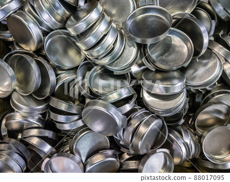 batch of olod stamped shiny metal caps, selective focus top-down wiew batch of olod stamped shiny metal caps, selective focus top-down wiew 88017095