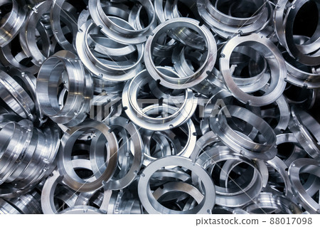 a batch of machined shiny metal parts with selective focus 88017098