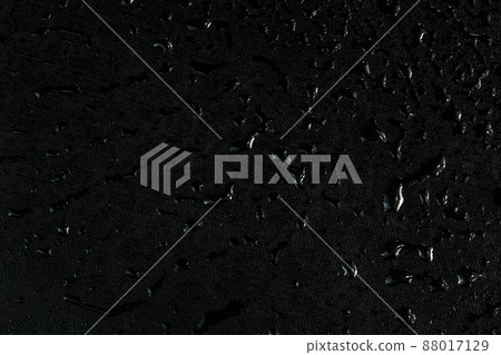 black flat rubber surface with water drops dark macro background black flat rubber surface with water drops dark macro background 88017129