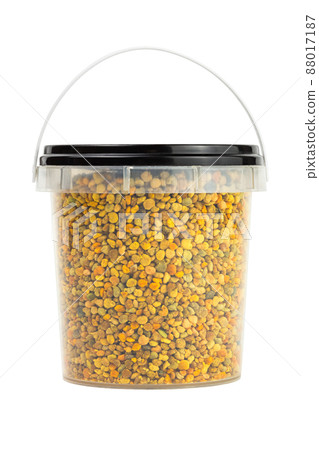 bee pollen granules in small plastic container isolated on white background 88017187