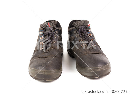 a pair of used blue leather work shoes with fabric incuts isolated on white background a pair of used blue leather work shoes with fabric incuts isolated on white background 88017231