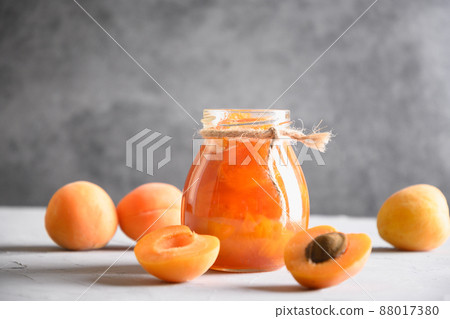 Apricot jam in glass jar with fruits. Summer harvest and canned food 88017380