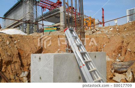 SELANGOR, MALAYSIA -JULY 4, 2021: The concrete pile cap and column stump are under construction at the construction site. Both are part of the building's foundation system. SELANGOR, MALAYSIA -JULY 4, 2021: The concrete pile cap and column stump are under construction at the construction site. Both are part of the building's foundation system. 88017709