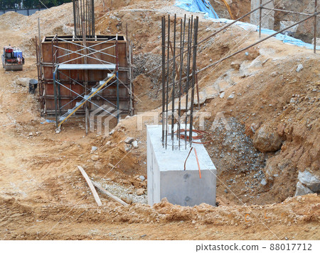 SELANGOR, MALAYSIA -JULY 4, 2021: The concrete pile cap and column stump are under construction at the construction site. Both are part of the building's foundation system. SELANGOR, MALAYSIA -JULY 4, 2021: The concrete pile cap and column stump are under construction at the construction site. Both are part of the building's foundation system. 88017712