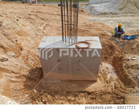 SELANGOR, MALAYSIA -JULY 4, 2021: The concrete pile cap and column stump are under construction at the construction site. Both are part of the building's foundation system. SELANGOR, MALAYSIA -JULY 4, 2021: The concrete pile cap and column stump are under construction at the construction site. Both are part of the building's foundation system. 88017721