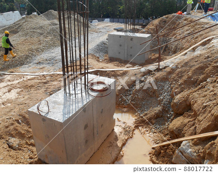 SELANGOR, MALAYSIA -JULY 4, 2021: The concrete pile cap and column stump are under construction at the construction site. Both are part of the building's foundation system. SELANGOR, MALAYSIA -JULY 4, 2021: The concrete pile cap and column stump are under construction at the construction site. Both are part of the building's foundation system. 88017722