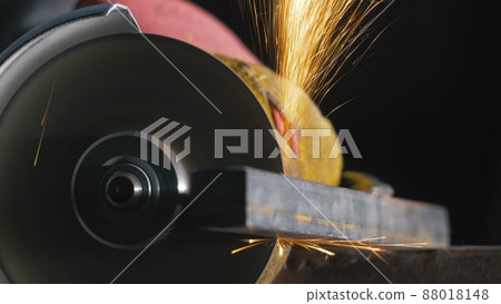 Forge workshop. Smithy manual production. Close up details of sparks, industrial worker using angle grinder and cutting steel. Forge workshop. Smithy manual production. Close up details of sparks, industrial worker using angle grinder and cutting steel. 88018148