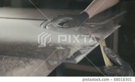 Glass cutting and processing for fireplace doors. Circular glass cutter. Worker cut glass with glass cutting diamond. Glass cutting and processing for fireplace doors. Circular glass cutter. Worker cut glass with glass cutting diamond. 88018301