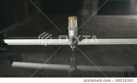 Glass cutting and processing for fireplace doors. Circular glass cutter. Worker cut glass with glass cutting diamond. Glass cutting and processing for fireplace doors. Circular glass cutter. Worker cut glass with glass cutting diamond. 88018365