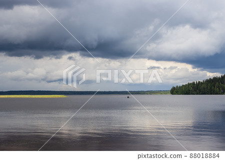 Landscape with a boat sailing on the lake 88018884