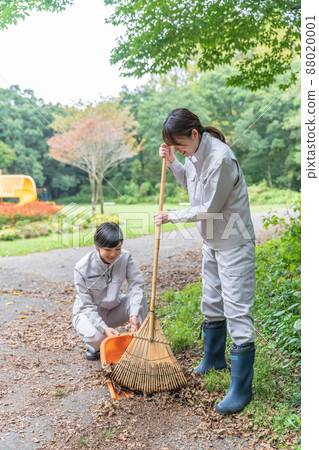 Female staff cleaning the park Female staff cleaning the park 88020001