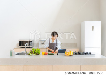A woman standing in the kitchen 88021535