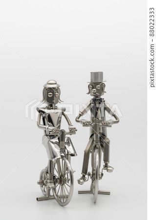 Gentlemen and ladies riding retro bicycles, metal figures Gentlemen and ladies riding retro bicycles, metal figures 88022333