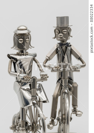 Gentlemen and ladies riding retro bicycles, metal figures Gentlemen and ladies riding retro bicycles, metal figures 88022334