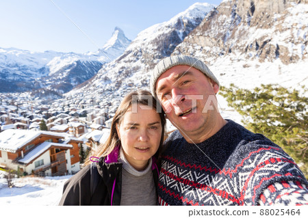 Happy couple taking selfie on background of mountains while traveling together 88025464