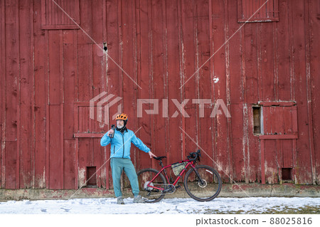 senior male cyclist is taking a break 88025816