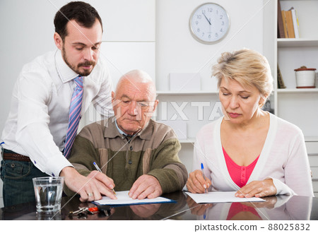 couple signing papers in bank 88025832