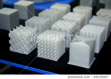 Objects printed on a 3d printer made of white plastic close-up. 88026067