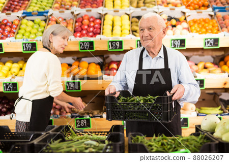 Senior supermarket workers doing their job Senior supermarket workers doing their job 88026207