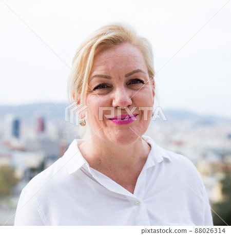 Happy confident senior woman smiling outdoors Happy confident senior woman smiling outdoors 88026314