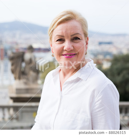Happy confident senior woman smiling outdoors Happy confident senior woman smiling outdoors 88026315